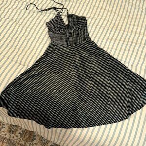 Elegant lusterous black and white striped midi dress with halter tie. Size 5/6